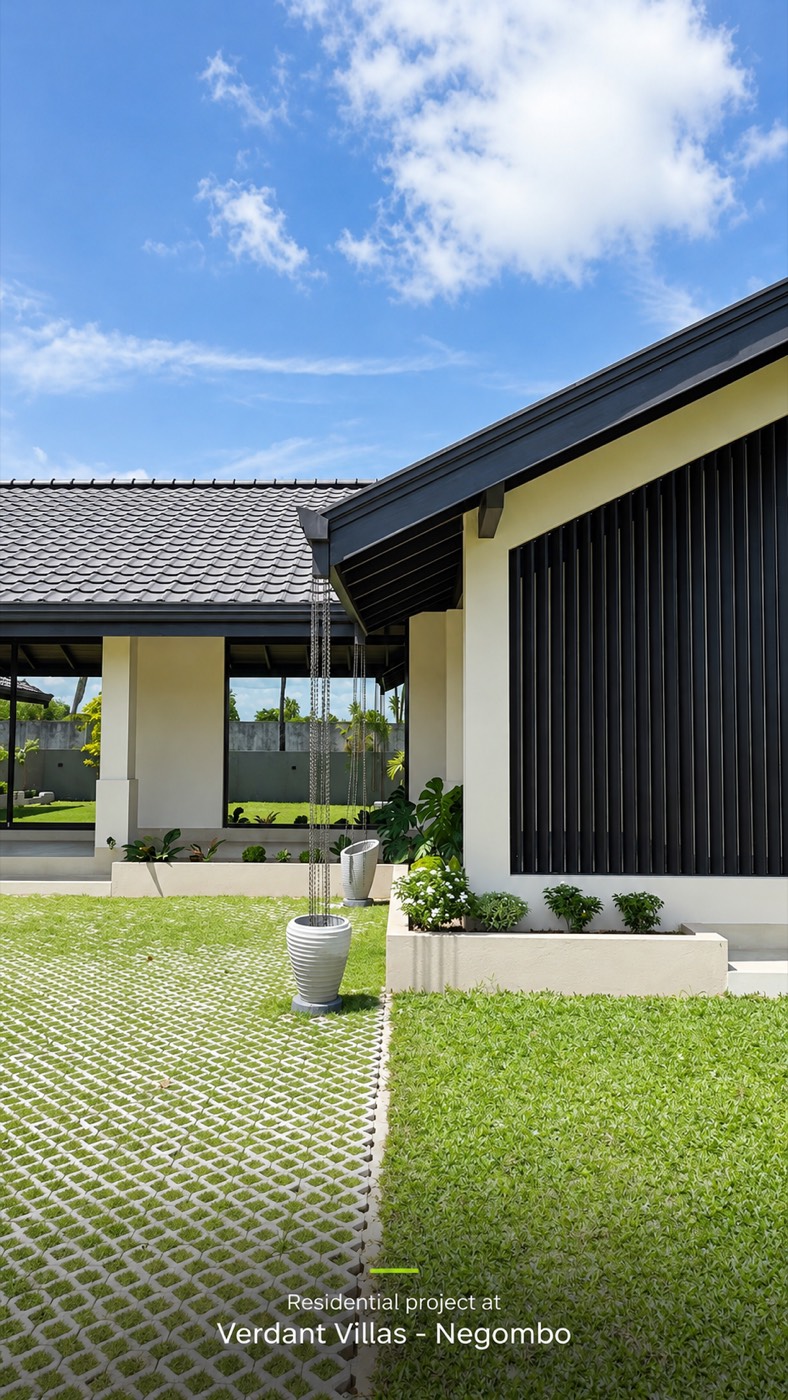 The bedroom wing with its dark vertical timber screen and wide glass doors onto the lawn