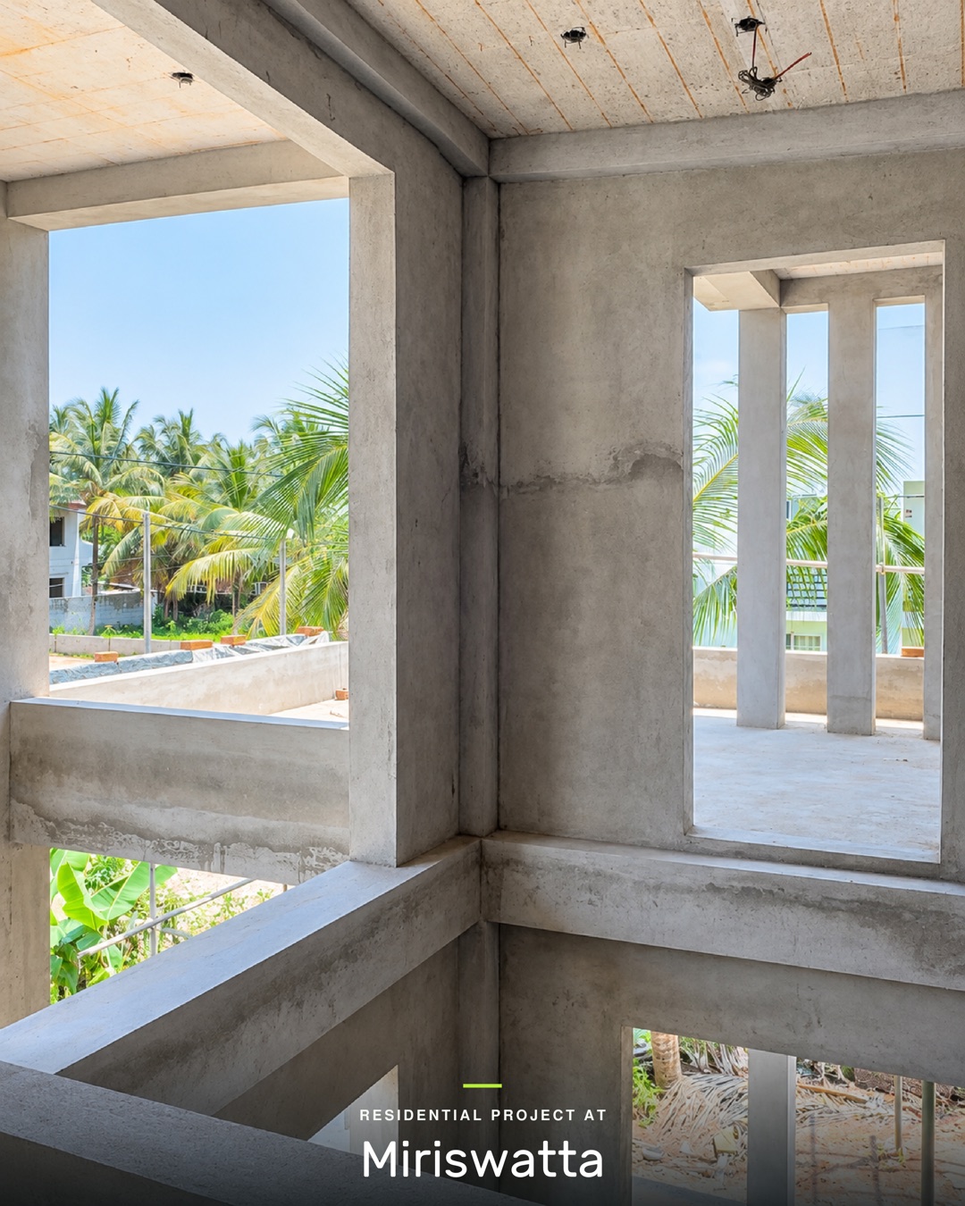 Upper floor corner with large plastered window openings looking out over coconut palms