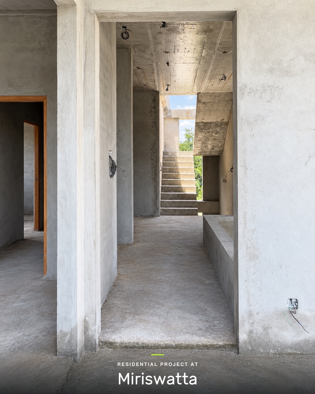 Plastered passage leading to the concrete staircase